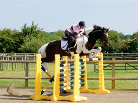 Photograph of horse and rider jumping over 3 fences. 3 Pairs of Yellow 8 Cups with 9 Pro Poles. Poles coloured Black, White & Yellow.