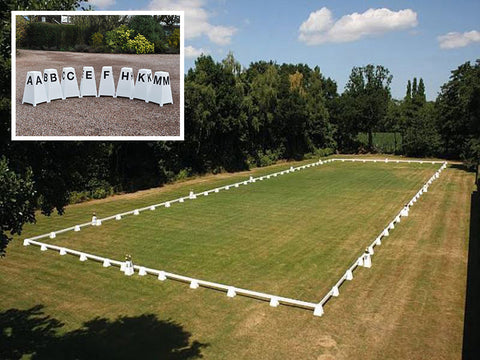 Photograph of Dressage Arena, 20 by 60 metres in field, complete with Dressage Tower Markers. Option includes 8 Dressage Tower Markers. 