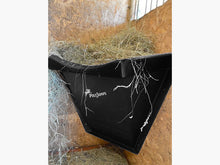 Load image into Gallery viewer, Black Hay Feeder attached to wall inside stables. 
