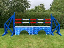 Load image into Gallery viewer, Photograph of a pair of Blue Cross Wings with 2 9 Band Practice Poles coloured: Red, Blue &amp; White. Underneath the poles sit 2 White Bridge Fillers with Blue Brick Graphics on them. 

