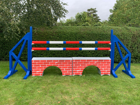 Photograph of a pair of Blue Cross Wings with 2 9 Band Practice Poles coloured: Red, Blue & White. Underneath the poles sit 2 White Bridge Fillers with Red Brick Graphics on them. 