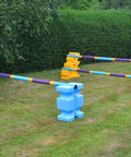 2 fences, from left to right. Pair of Baby Blue PolyJump Blocks with 1 9 Band Practice Poles Club Style. 1 Pair of Yellow MultiJumps with 2 Club Style Poles. 