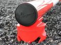 End Cap of Pole showing the embosses PolyJumps logo. Pole is sitting on a Red PolePod. 