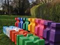 Collection of PolyJump Blocks of all different colours in field.