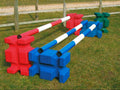 Collection of multi coloured PolyJump Blocks. Each with a matching coloured pole on top. 