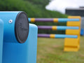 Close up photograph of the end cap on a practice pole. PolyJump Logo embossed onto the cap.