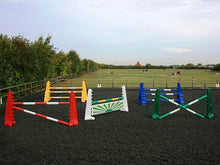 Load image into Gallery viewer, From left to right, 1 pair of red 8 cups with 2 5 band poles in red and white. 1 pair of yellow 8 Cups and yellow MultiJumps with 3 5 Band Poles. In the centre is a pair of white 8 Cups with 1 5 Band Pole in green and yellow with a green and yellow sunrise large hanging filler below it. 1 pair of blue 8 Cups and Blue MultiJumps with 3 5 Band Poles in blue and white. On the right is a pair of green 8 Cups with 2 green and white poles. All jumps in an arena.
