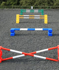 4 rows of jumps. From front to back is a red pair of PolyJump Blocks with 2 5 band red and white poles. Behind that fence is the same in blue. Then a pair of yellow MultiJumps with 2 yellow and white 5 band poles. Finally a pair of green MultiJumps with green and white poles. 