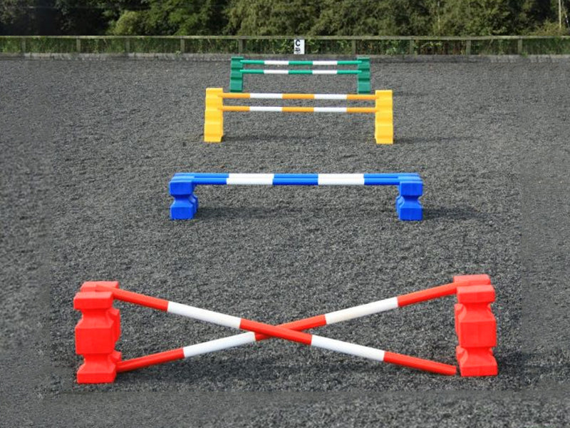 4 rows of jumps. From front to back is a red pair of PolyJump Blocks with 2 5 band red and white poles. Behind that fence is the same in blue. Then a pair of yellow MultiJumps with 2 yellow and white 5 band poles. Finally a pair of green MultiJumps with green and white poles. 