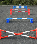 4 rows of jumps. From front to back is a red pair of PolyJump Blocks with 2 5 band red and white poles. Behind that fence is the same in blue. Then a pair of red MultiJumps with 2 red and white 5 band poles. Finally a pair of blue MultiJumps with blue and white poles.