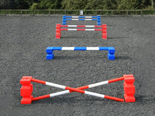 Load image into Gallery viewer, 4 rows of jumps. From front to back is a red pair of PolyJump Blocks with 2 5 band red and white poles. Behind that fence is the same in blue. Then a pair of red MultiJumps with 2 red and white 5 band poles. Finally a pair of blue MultiJumps with blue and white poles.
