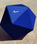 Blue Treat Ball on floor with white PolyJumps logo facing upward.
