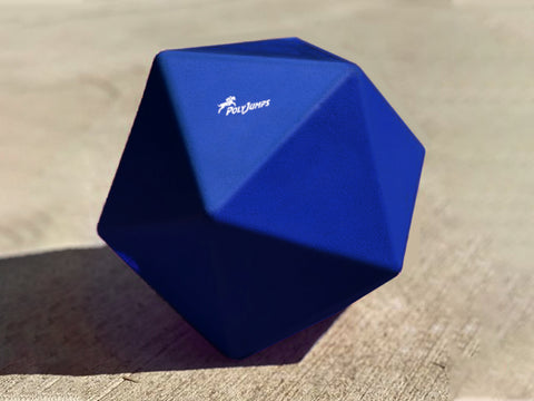 Blue Treat Ball on floor with white PolyJumps logo facing upward.